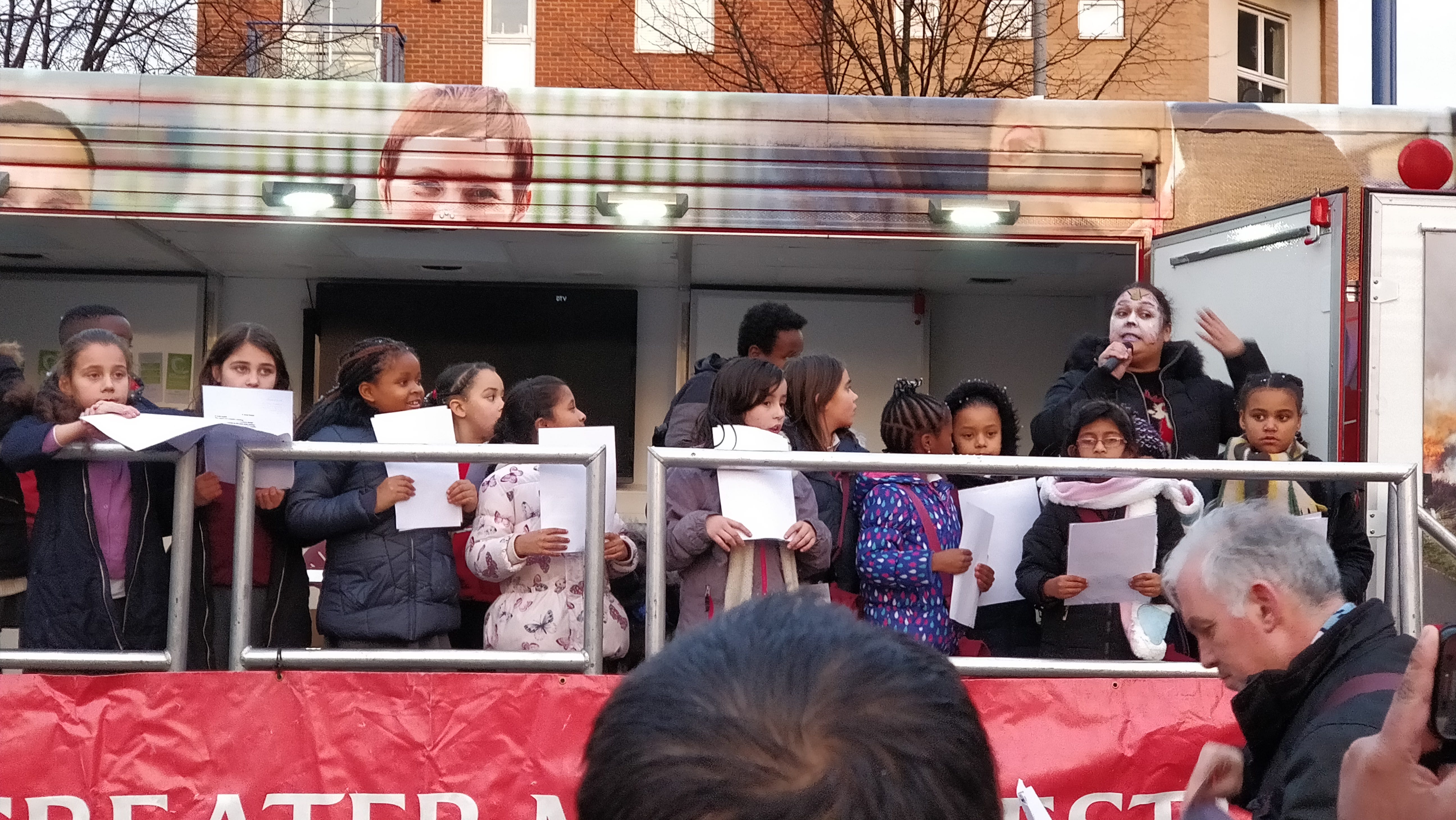 school children singing on a bus